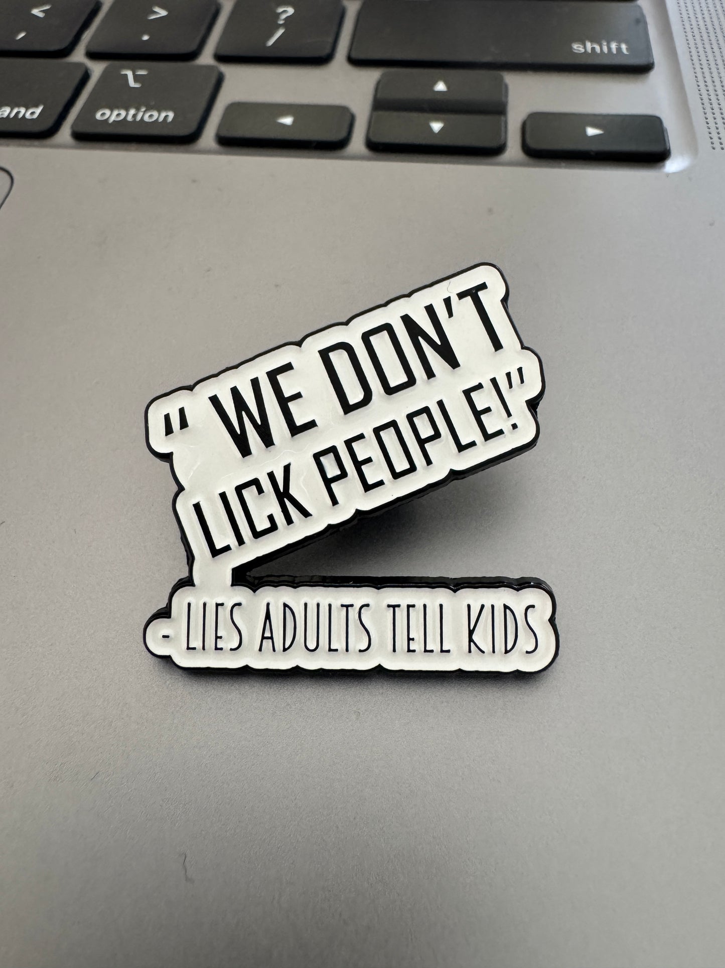 'We don't lick people' enamel pin