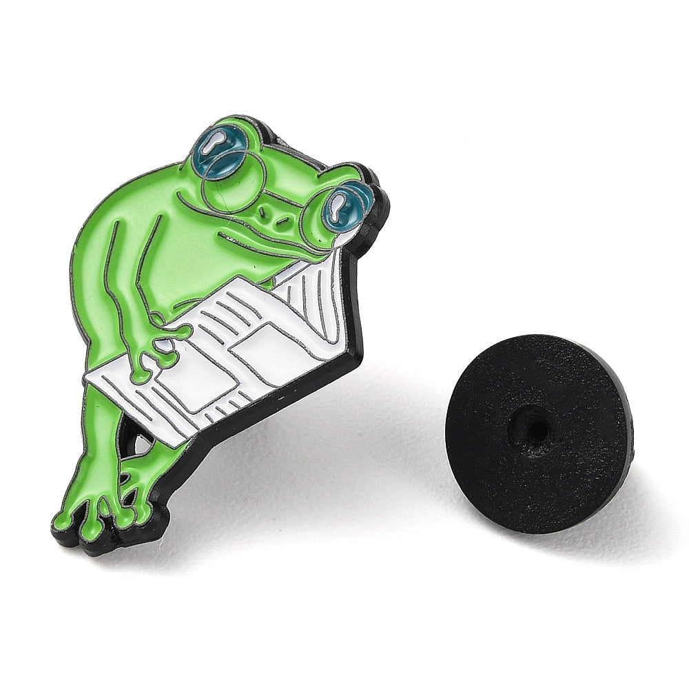 Frog reading a newspaper enamel pin