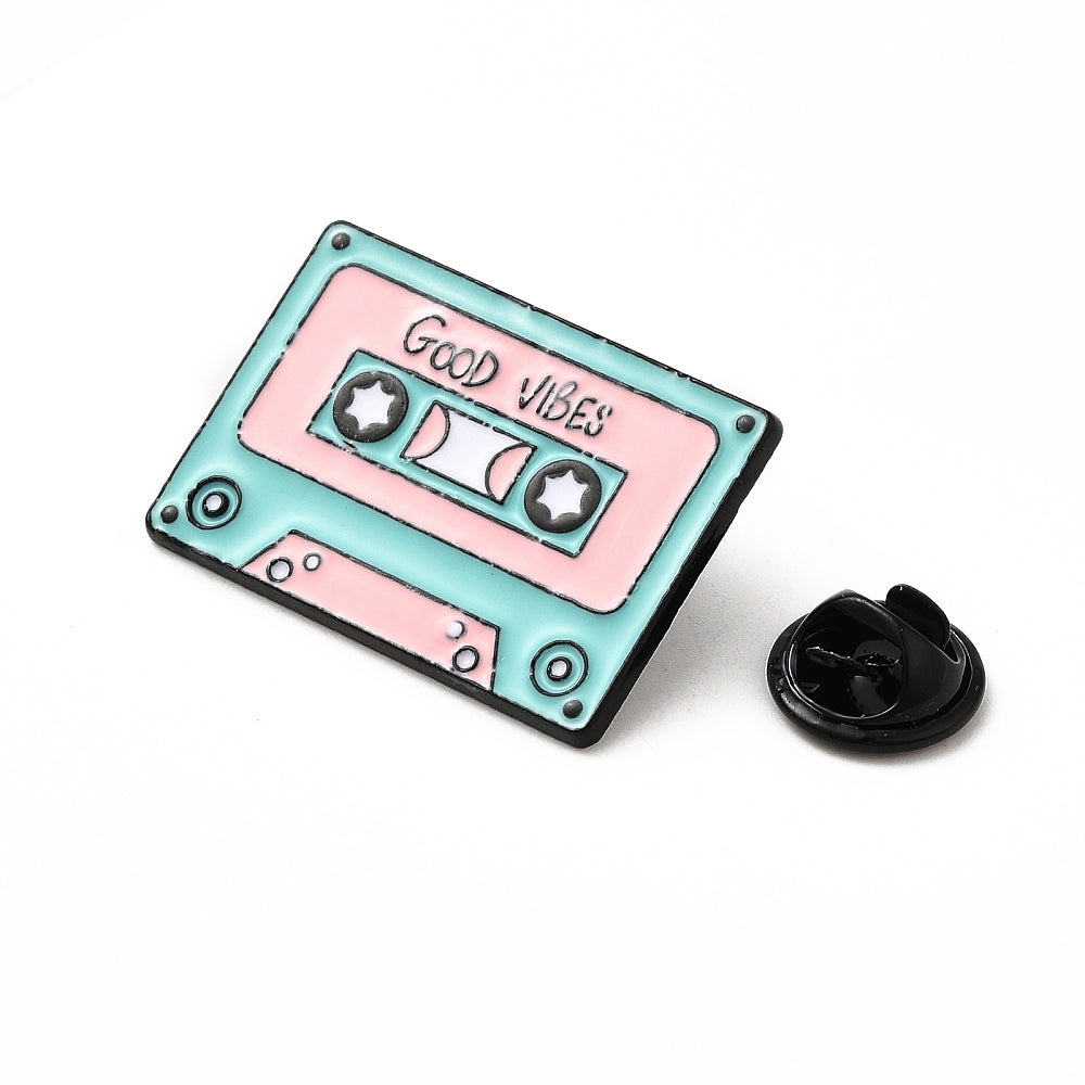 Cassette tape with 'good vibes' enamel pin