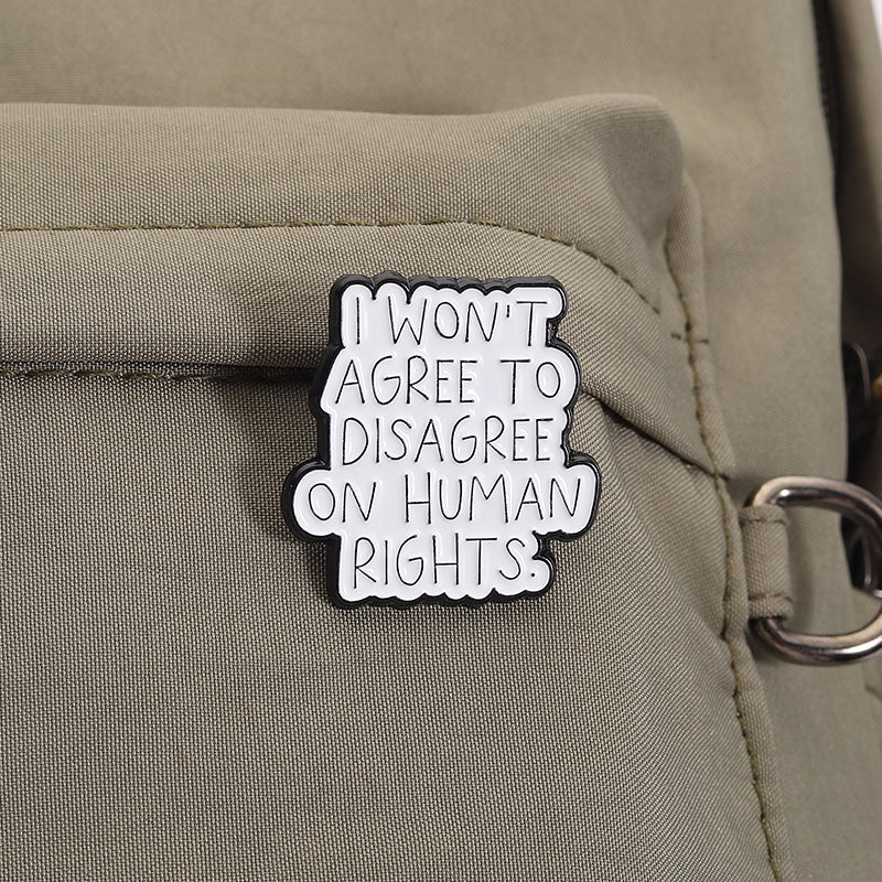'I won't agree to disagree on human rights.' enamel pin