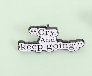 'Cry and keep going' enamel pin