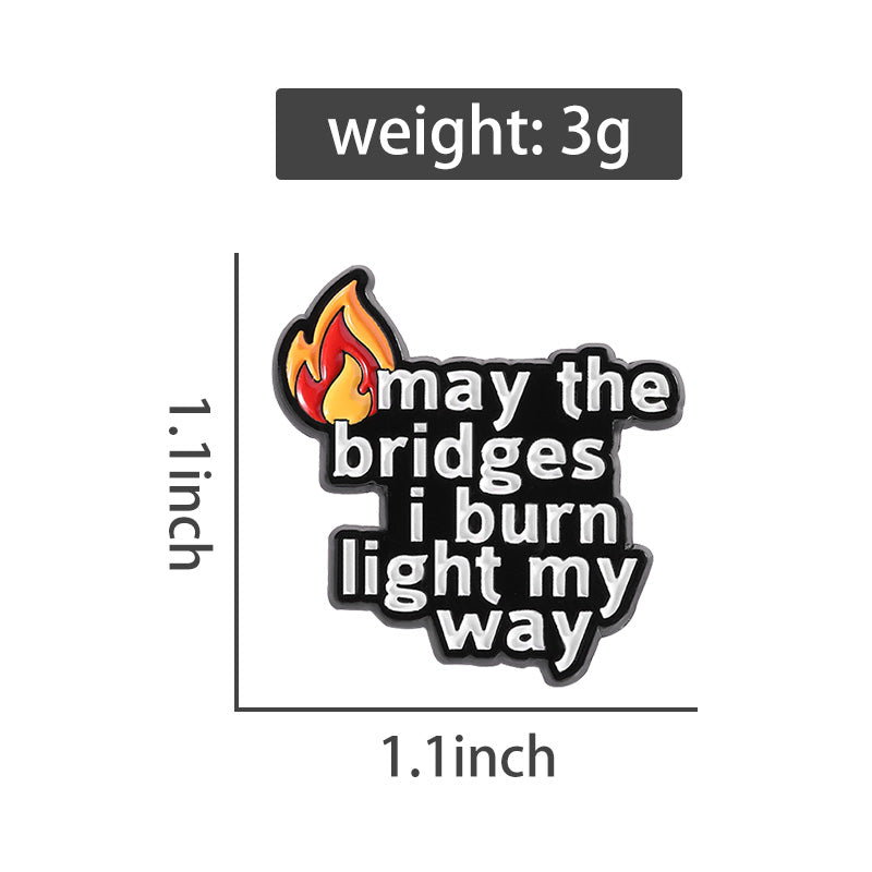 'may the bridges i burn light the way' enamel pin