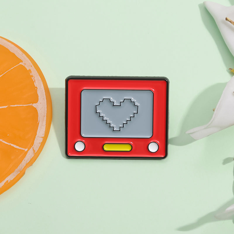 Red drawing tech pad with a love heart enamel pin