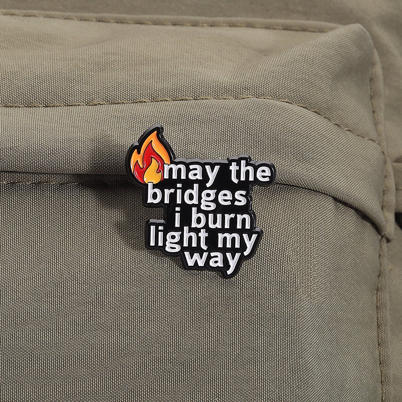 'may the bridges i burn light the way' enamel pin