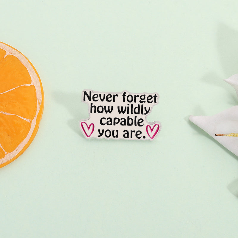 'Never forget how wildly capable you are' enamel pin