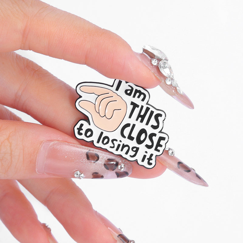 'I am this close to losing it' enamel pin