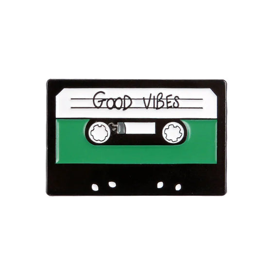 Cassette tape with 'good vibes' enamel pin